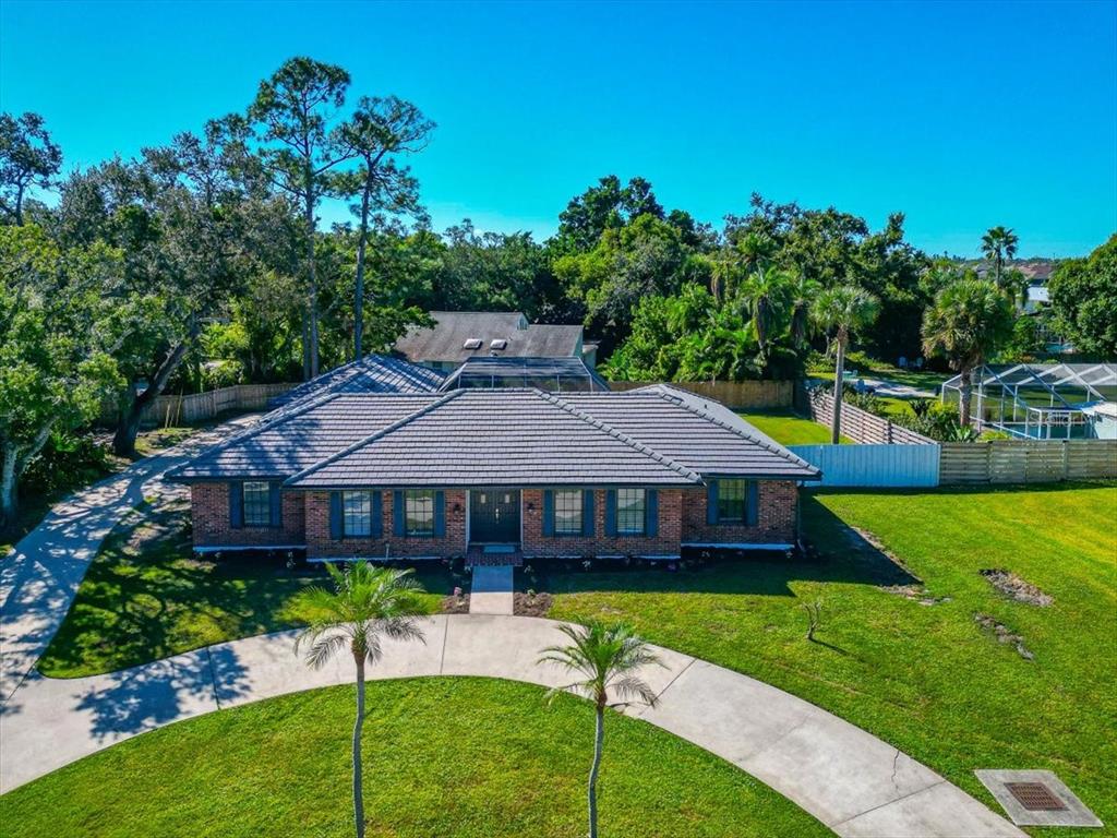 a view of a house with a yard and sitting area