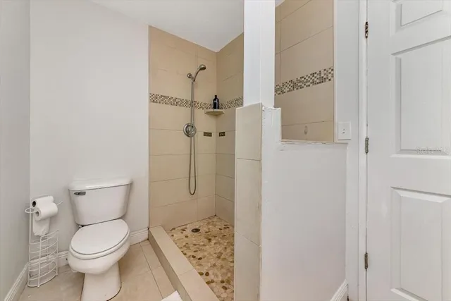 a bathroom with a toilet and a shower