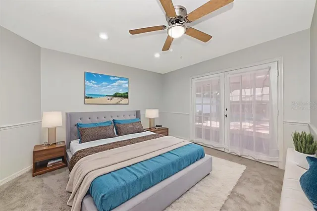 a bedroom with a large bed and a chandelier