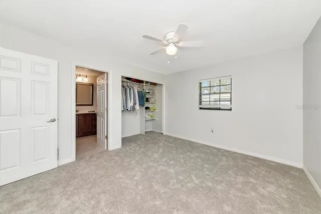 an empty room with closet and windows