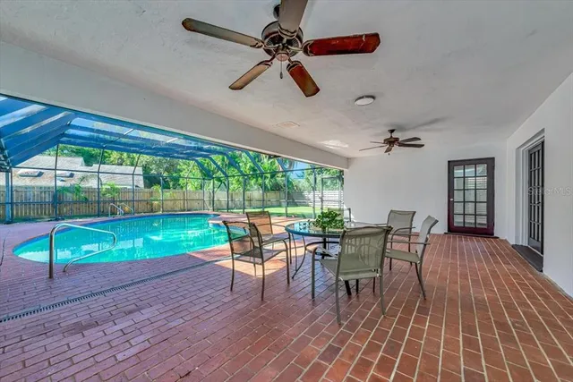 a dining room with furniture water view and a floor to ceiling window