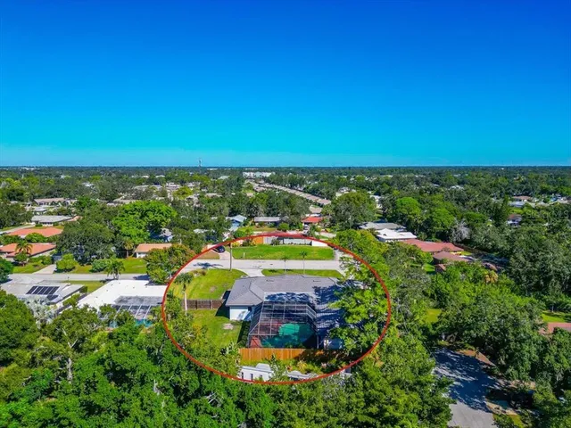 an aerial view of residential houses with outdoor space and swimming pool
