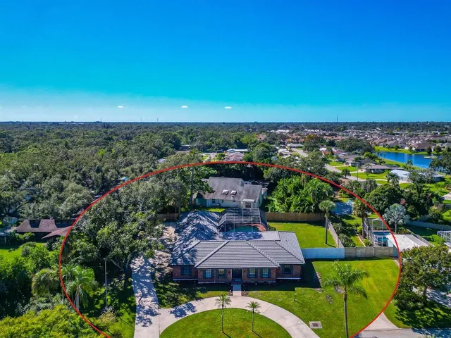 a view of a city with lawn chairs under an umbrella