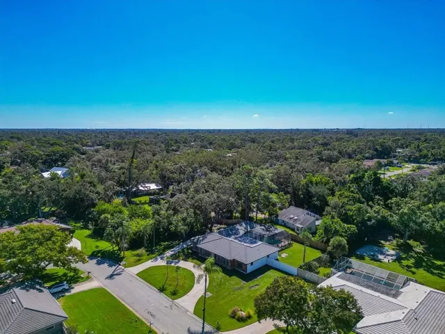 an aerial view of a house with a yard