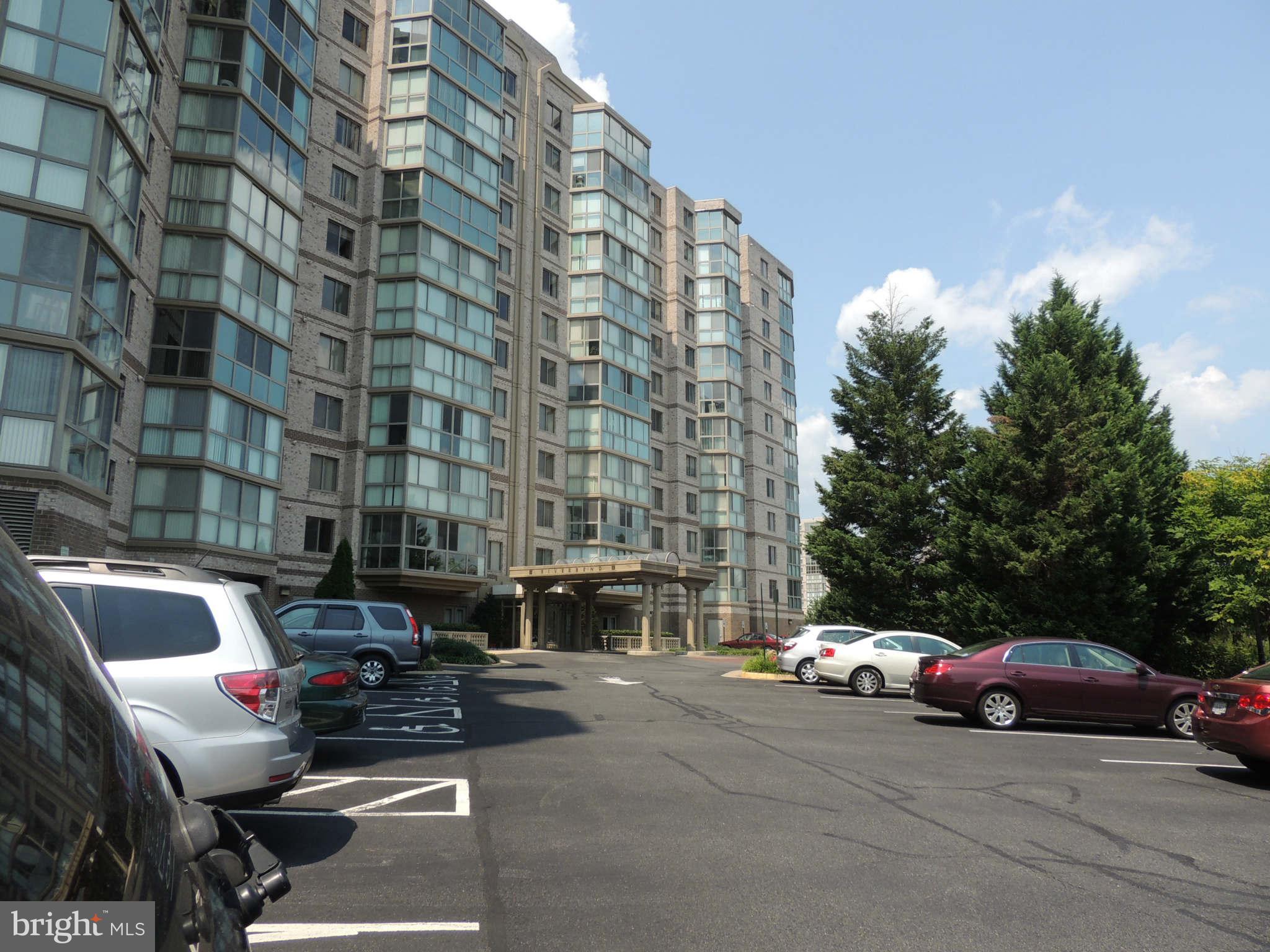 19385 Cypress Ridge Terrace, Unit 619 Leesburg, VA 20176 - Photo 1 of 17 a car parked in front of a building