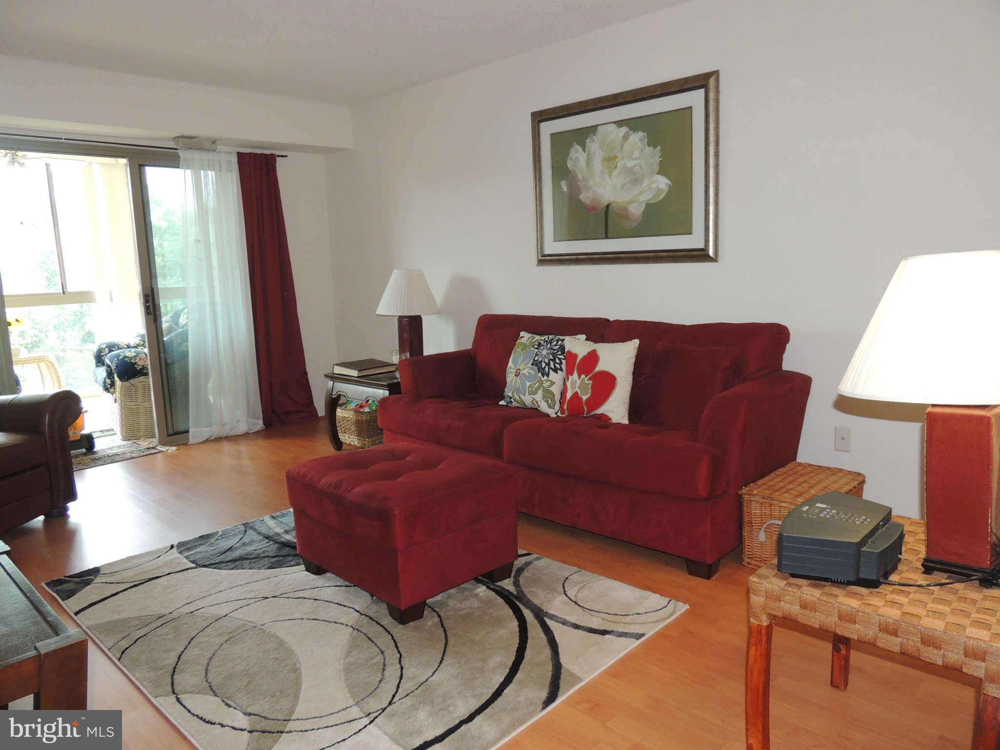 19385 Cypress Ridge Terrace, Unit 619 Leesburg, VA 20176 - Photo 2 of 17 a living room with furniture and a large window