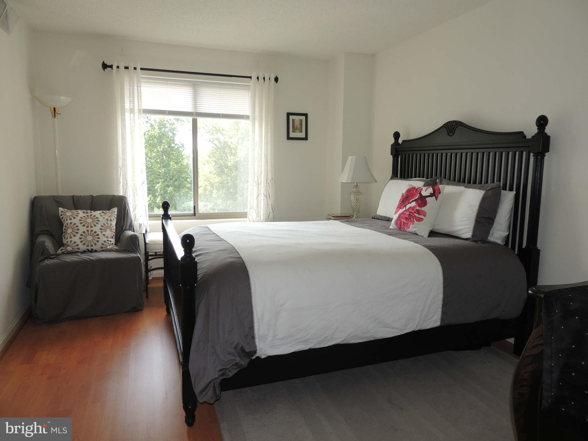 19385 Cypress Ridge Terrace, Unit 619 Leesburg, VA 20176 - Photo 11 of 17 a bedroom with bed and window