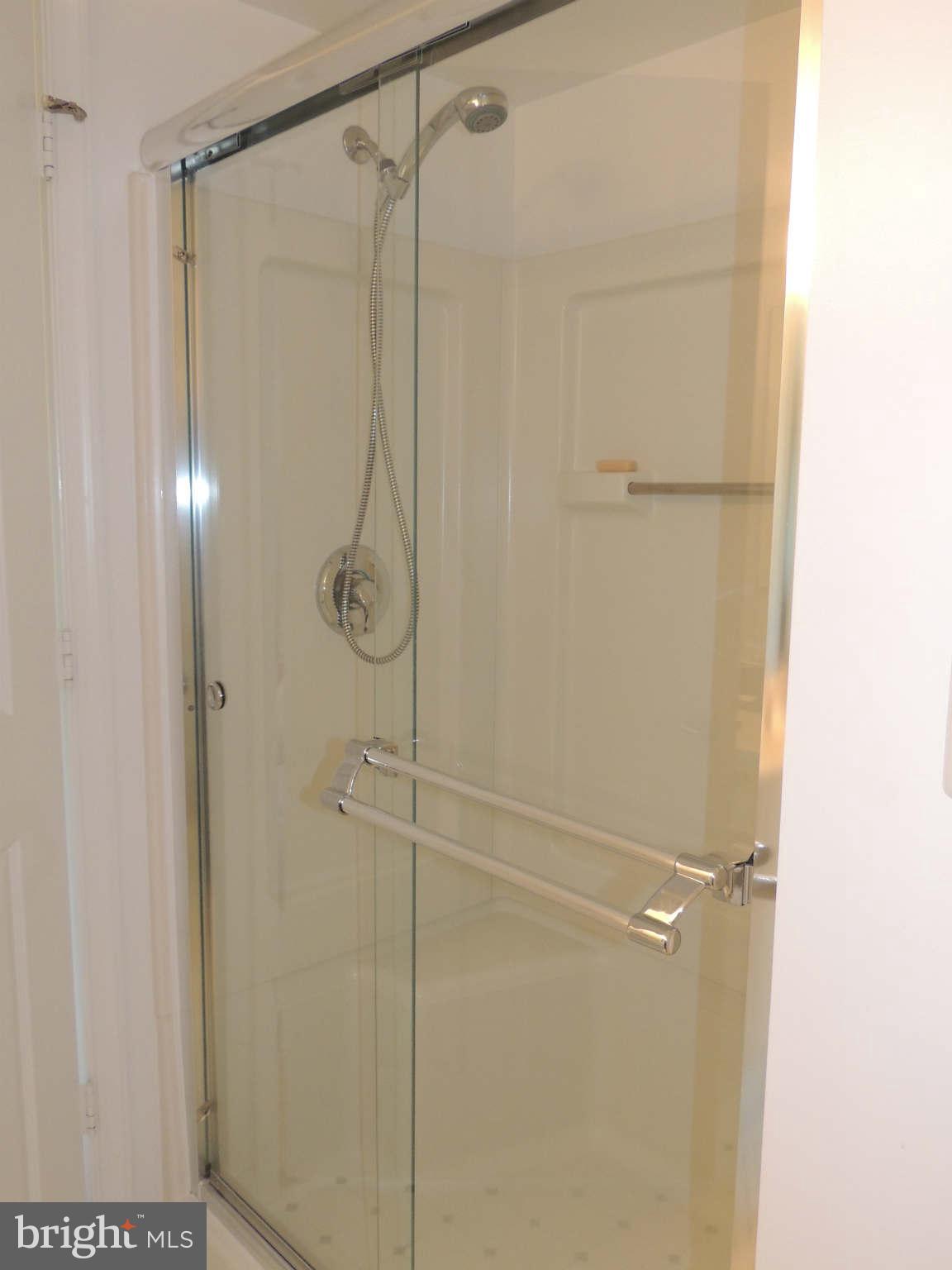 19385 Cypress Ridge Terrace, Unit 619 Leesburg, VA 20176 - Photo 15 of 17 a bathroom with a glass shower door