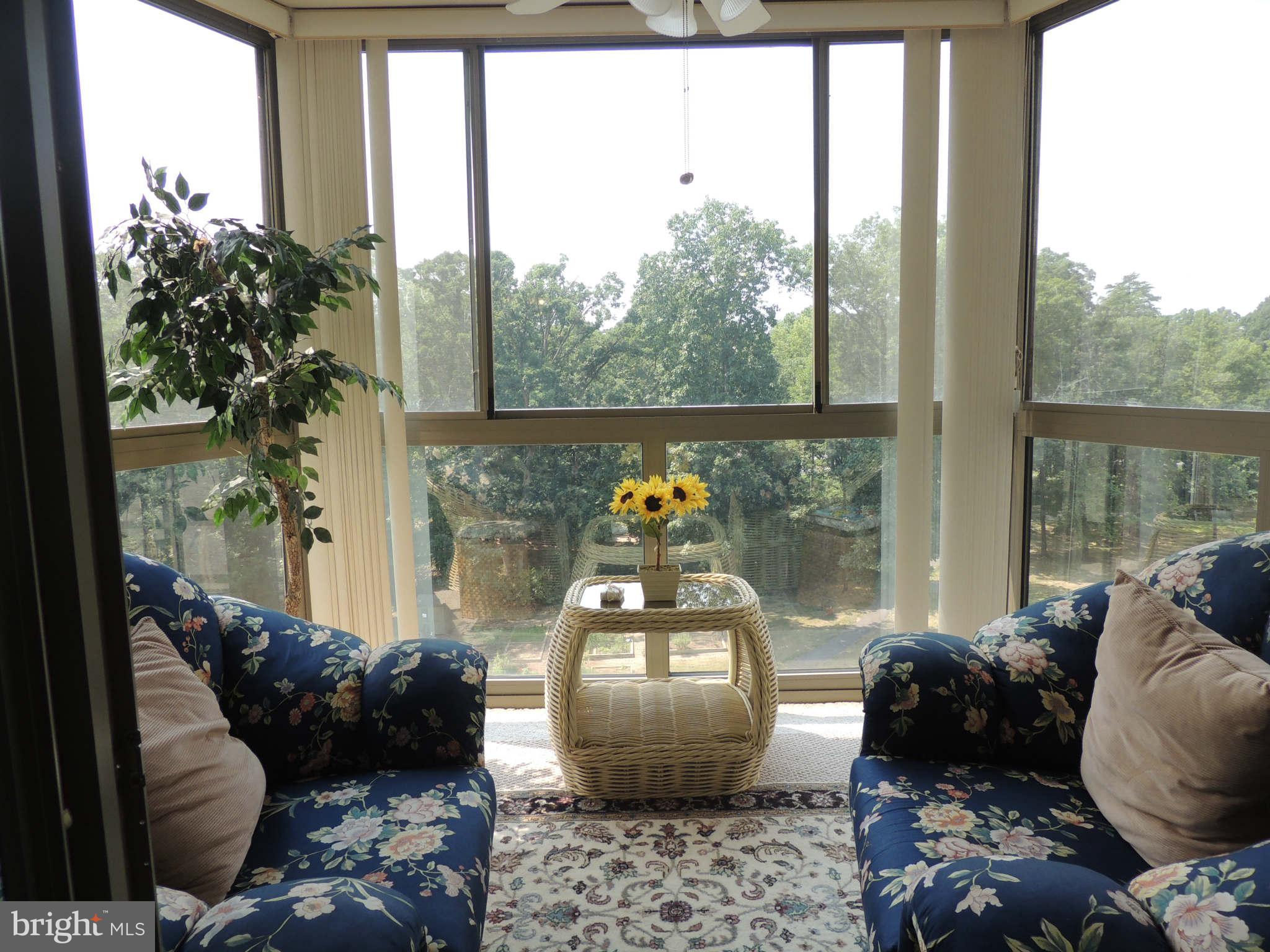 19385 Cypress Ridge Terrace, Unit 619 Leesburg, VA 20176 - Photo 16 of 17 a living room filled with furniture and a potted plant