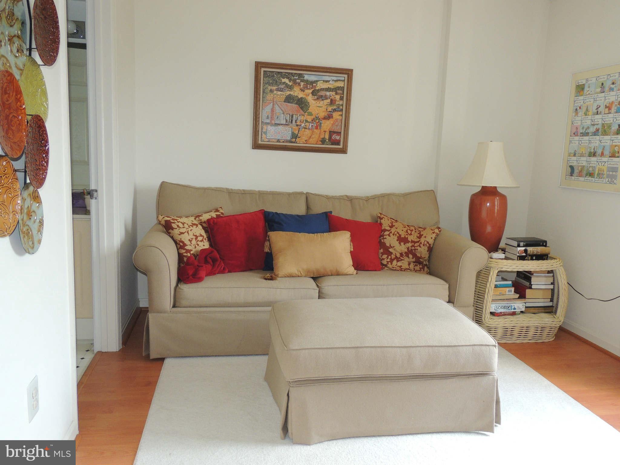 19385 Cypress Ridge Terrace, Unit 619 Leesburg, VA 20176 - Photo 4 of 17 a living room with furniture and a couch