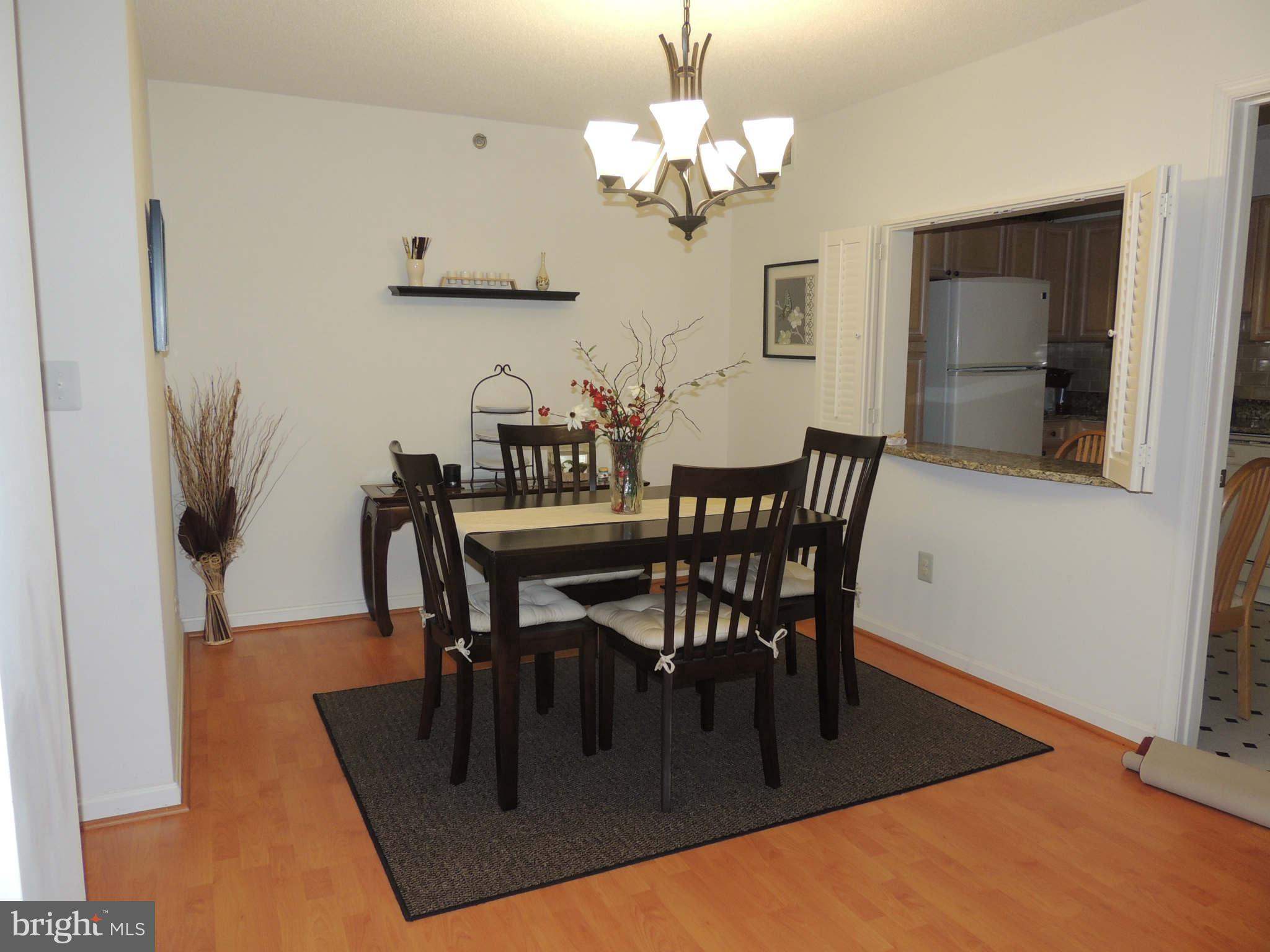 19385 Cypress Ridge Terrace, Unit 619 Leesburg, VA 20176 - Photo 5 of 17 a view of a dining room with furniture and wooden floor