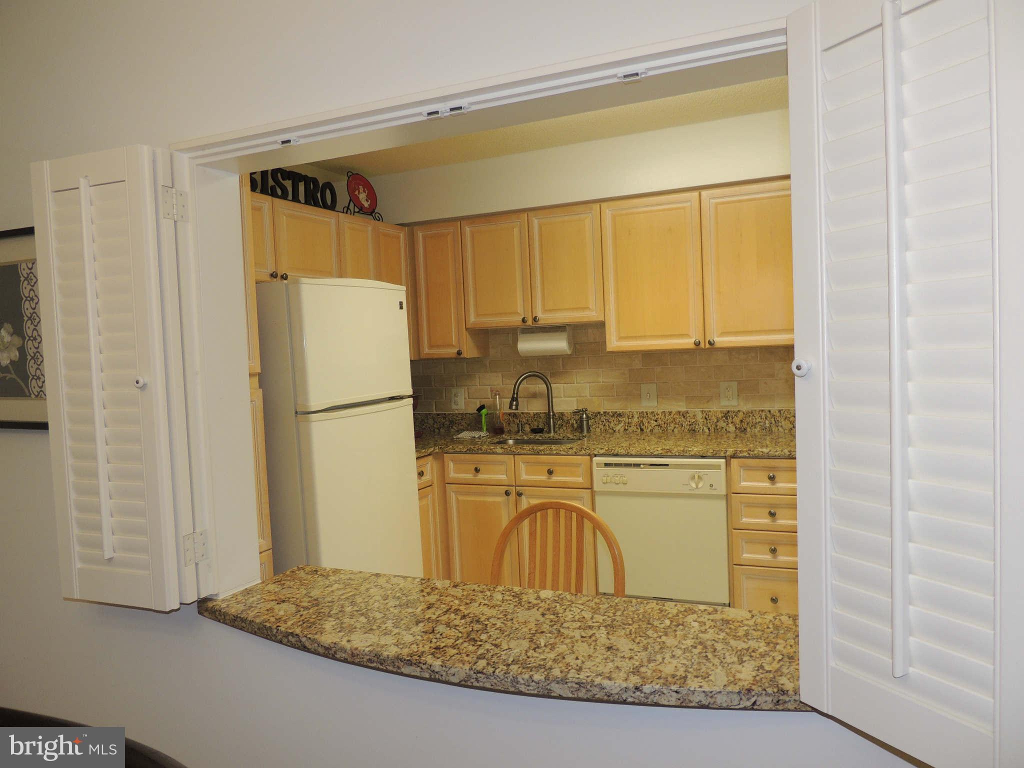 19385 Cypress Ridge Terrace, Unit 619 Leesburg, VA 20176 - Photo 6 of 17 a kitchen with a refrigerator and a cabinets