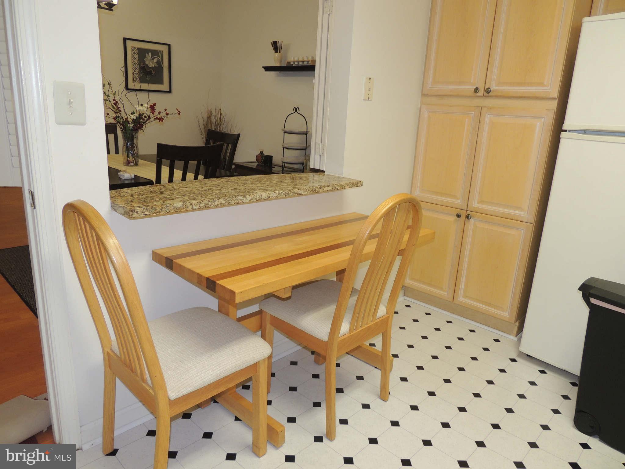 19385 Cypress Ridge Terrace, Unit 619 Leesburg, VA 20176 - Photo 7 of 17 a dining room with furniture and wooden floor