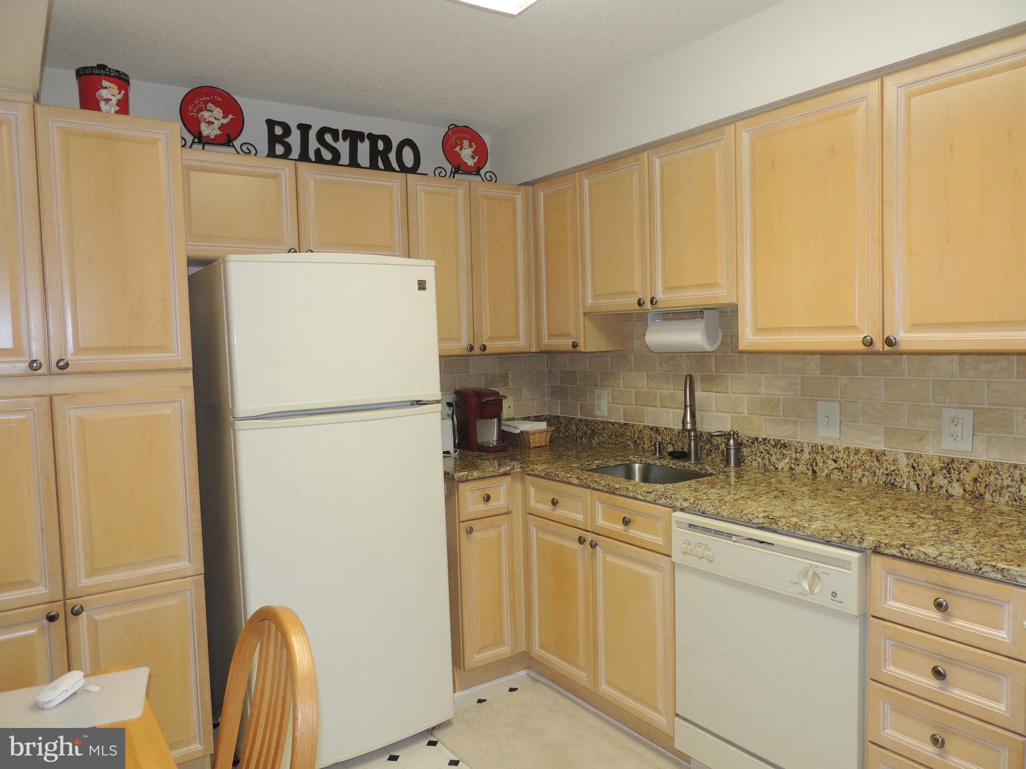 19385 Cypress Ridge Terrace, Unit 619 Leesburg, VA 20176 - Photo 8 of 17 a kitchen with appliances a sink and cabinets