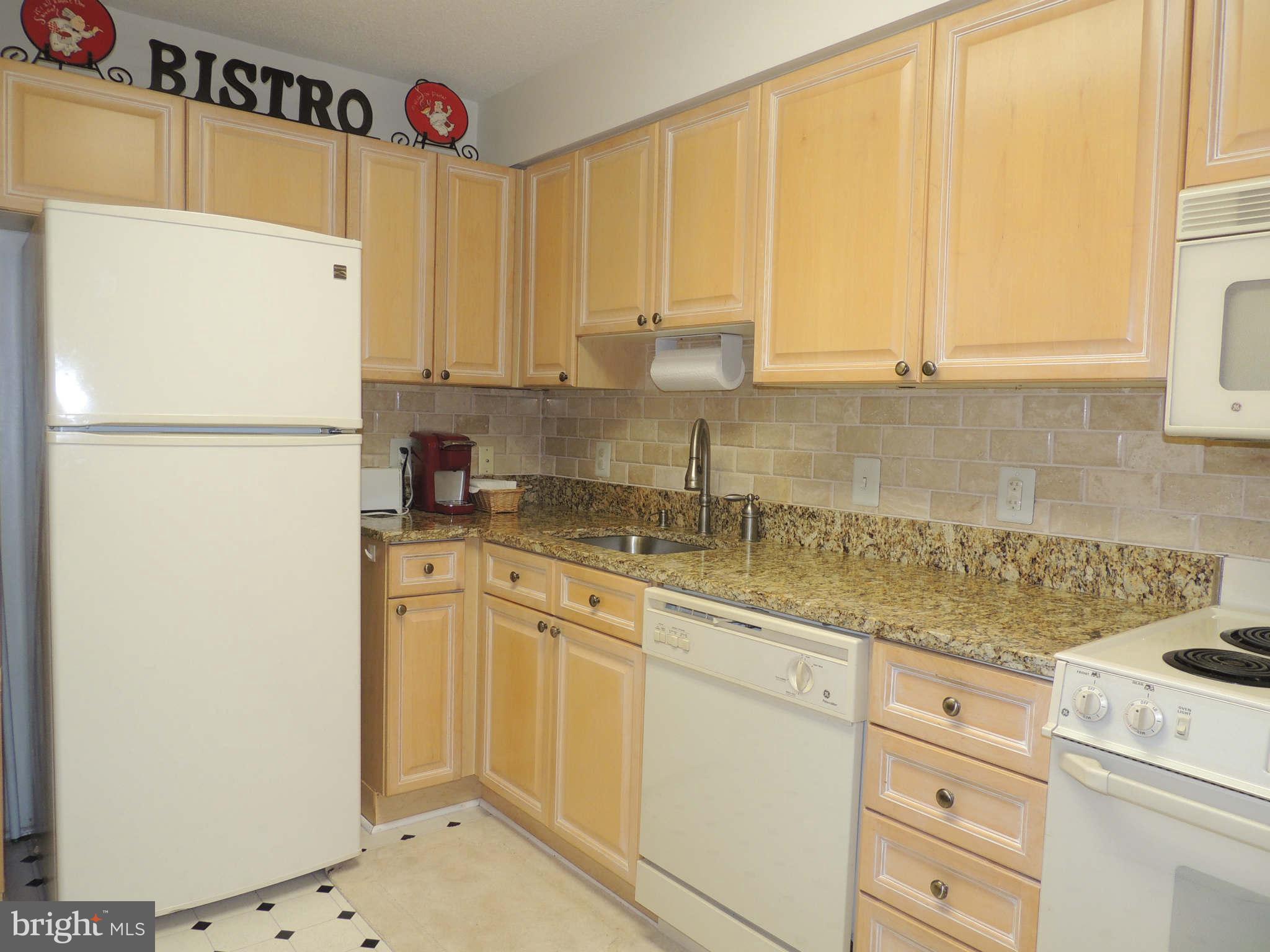 19385 Cypress Ridge Terrace, Unit 619 Leesburg, VA 20176 - Photo 10 of 17 a white refrigerator freezer sitting inside of a kitchen