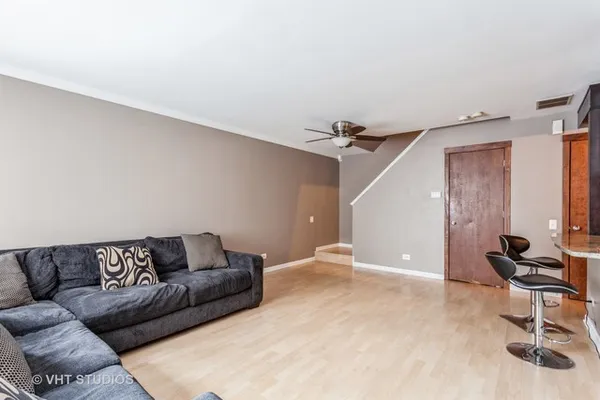 a living room with furniture and a gym machine