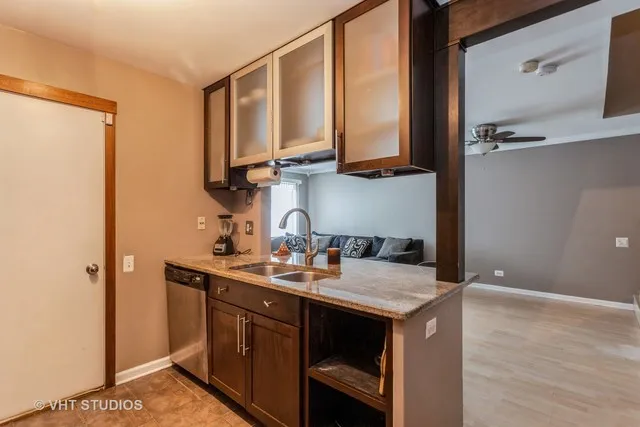 a kitchen with a sink a stove and cabinets