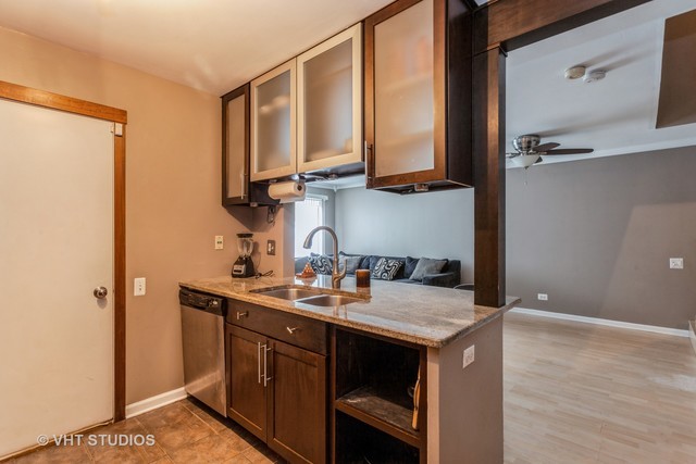 1410 Normantown Road, Unit 1410 Naperville, IL 60564 - Photo 6 of 10 a kitchen with a sink a stove and cabinets