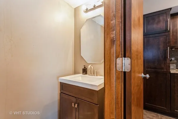 a bathroom with a sink vanity and a mirror