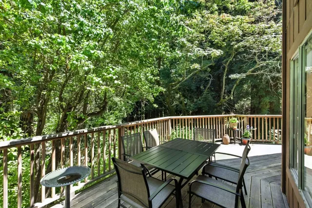 a view of a patio with table and chairs under an umbrella