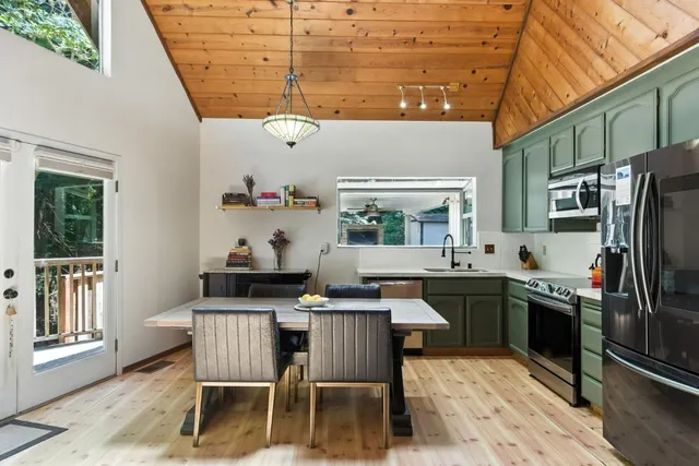a kitchen with a dining table and chairs