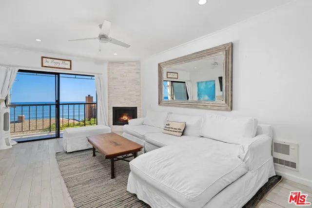 a living room with furniture a fireplace and a table