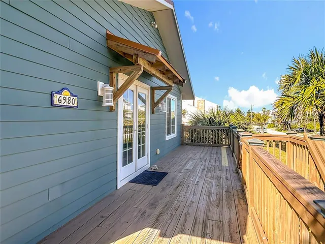 a kitchen with granite countertop a sink stainless steel appliances white cabinets and a window