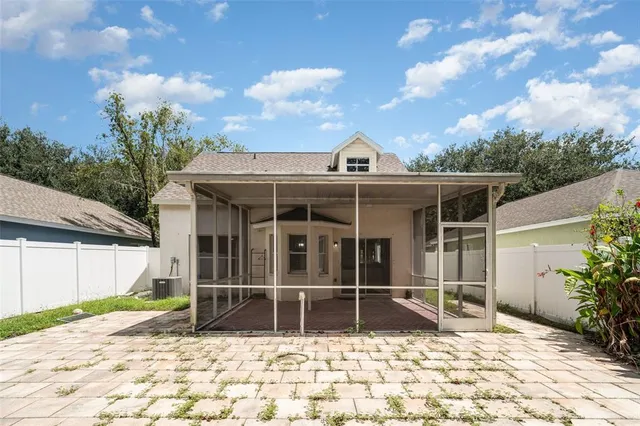 a view of a house with a chair and floor to ceiling window