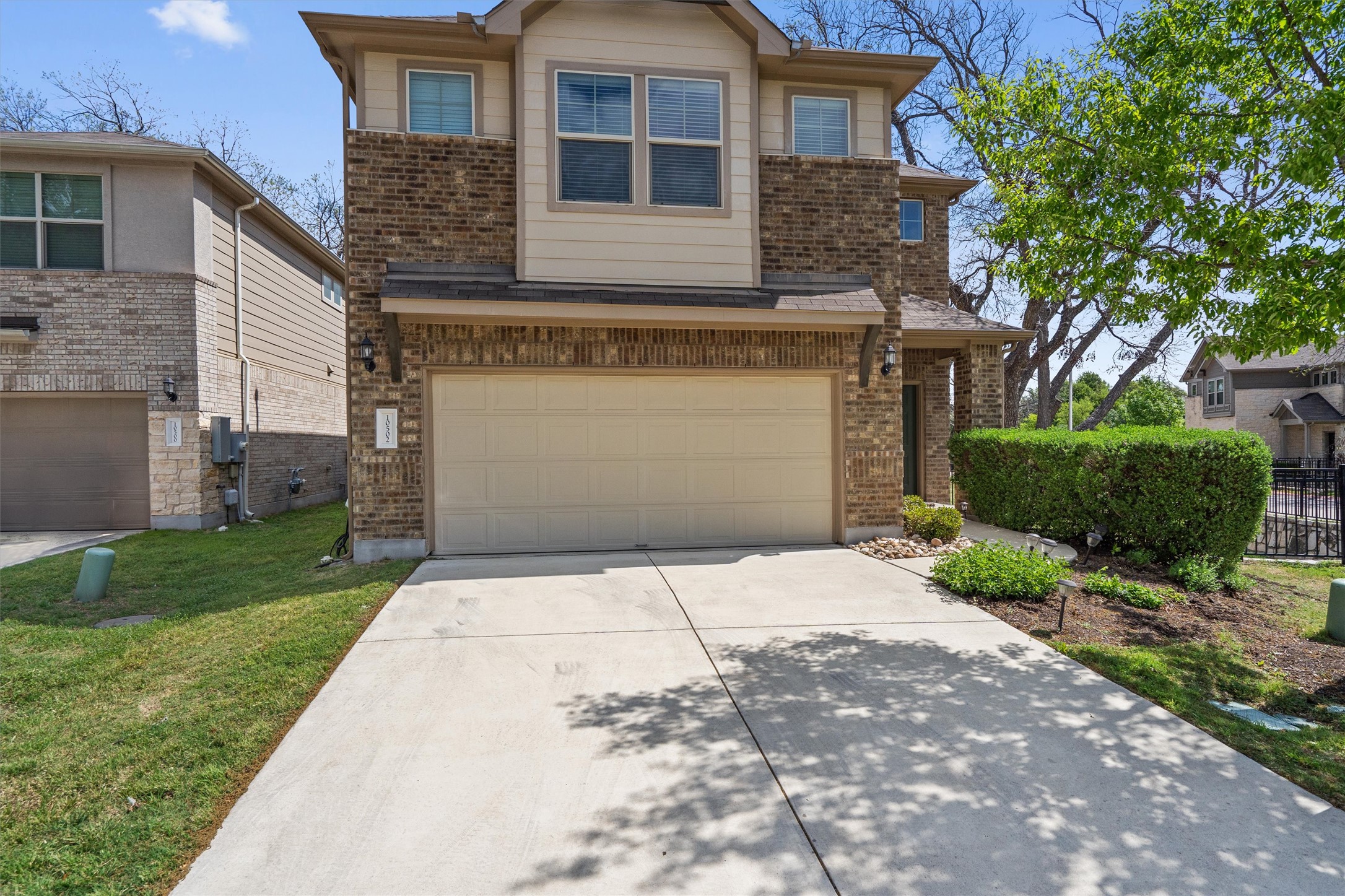 10502 Turnbull Loop, Unit 41 Austin, TX 78717 - Photo 1 of 35 a front view of a house with a yard and garage