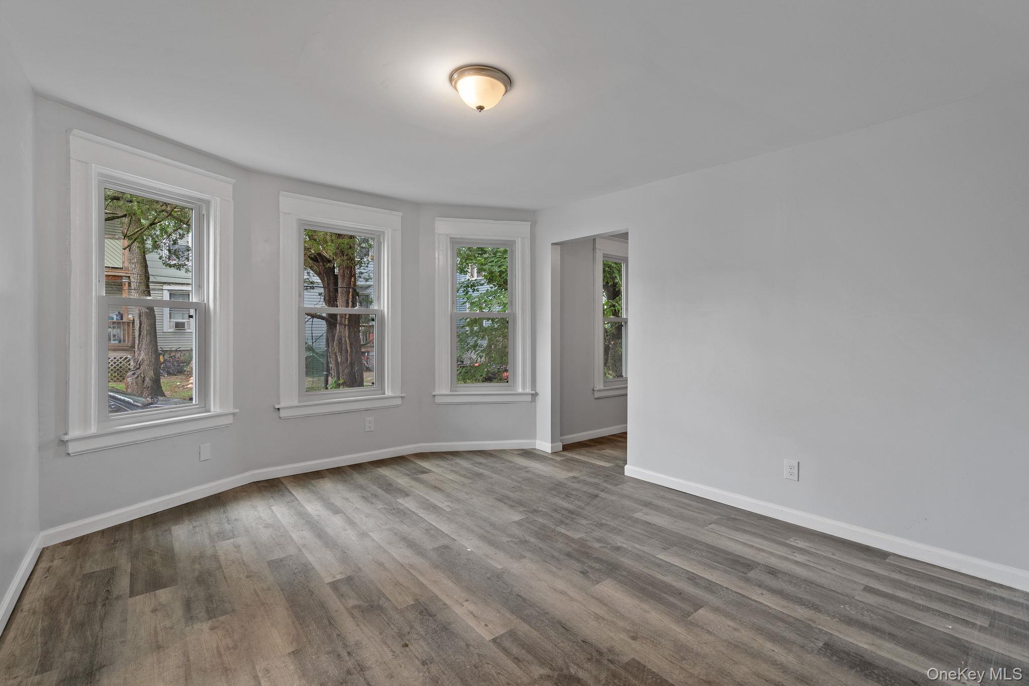 21 Lent Street Poughkeepsie, NY 12601 - Photo 17 of 47 Empty room with plenty of natural light and wood finished floors
