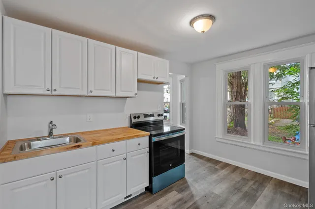 a kitchen with stainless steel appliances granite countertop a sink stove and cabinets