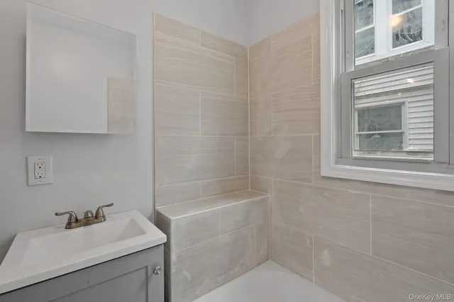 a bathroom with a sink toilet and tub