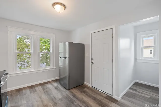 an empty room with windows and closet