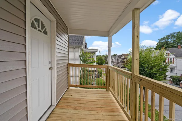a view of a balcony with wooden floor