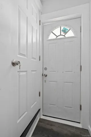 an empty room with wooden floor and door