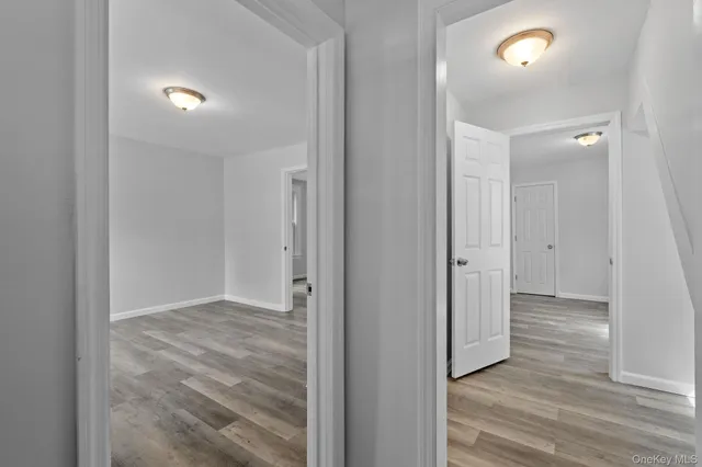 a view of hallway with wooden floor