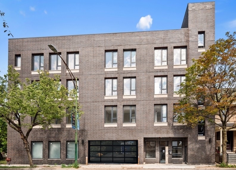 3839 North Clark Street, Unit 403 Chicago, IL 60613 - Photo 1 of 8 a front view of a residential apartment building with a yard