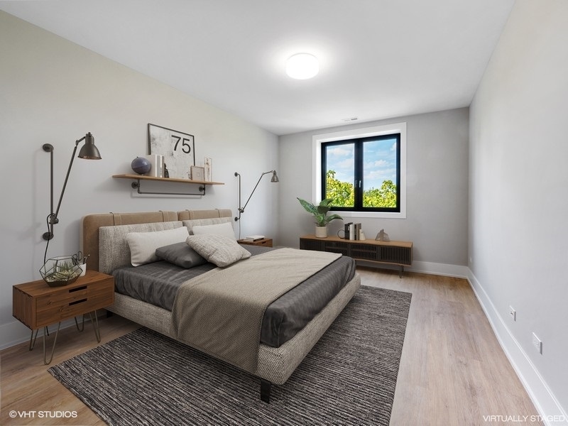 3839 North Clark Street, Unit 403 Chicago, IL 60613 - Photo 6 of 8 a bedroom with a bed and window