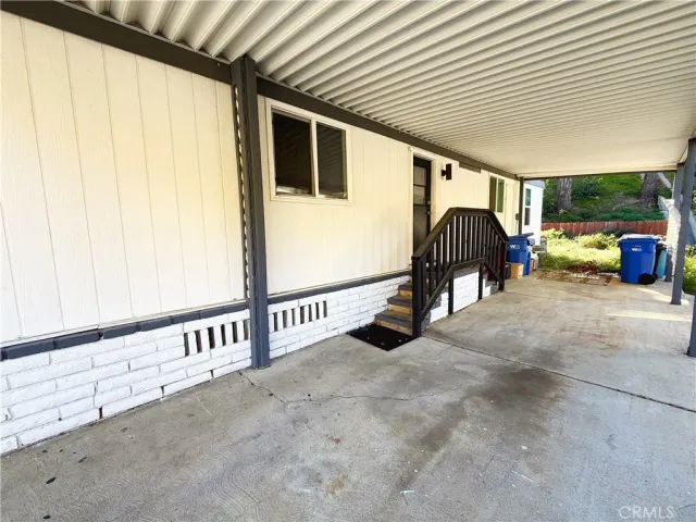 a view of a porch with furniture and a garage