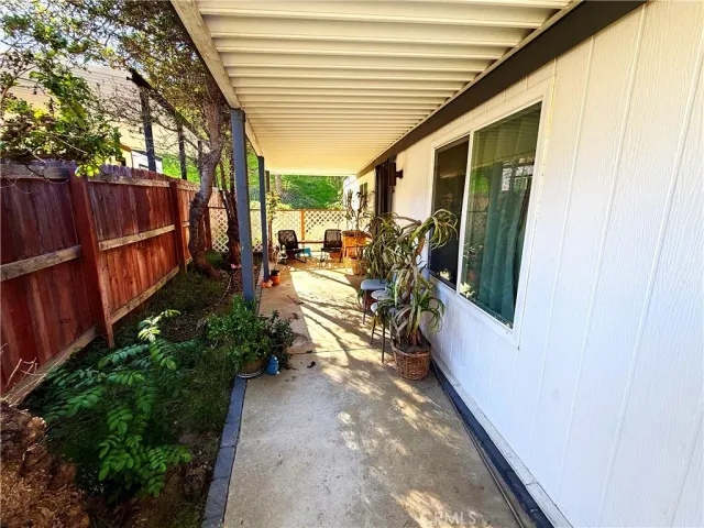 a view of a porch with furniture and garden