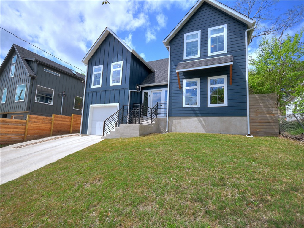 a front view of a house with a yard and garage