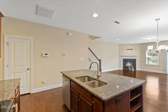 a kitchen with stainless steel appliances granite countertop a refrigerator sink and microwave