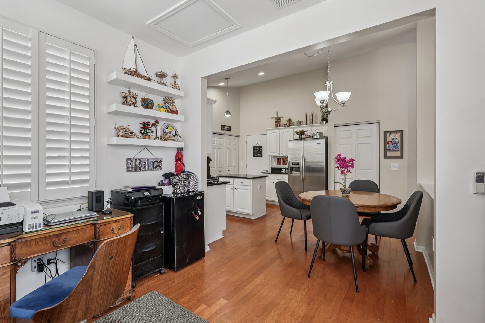 688 Cadillac Circle Romeoville, IL 60446 - Photo 13 of 45 a kitchen with granite countertop a dining table chairs stove and white cabinets