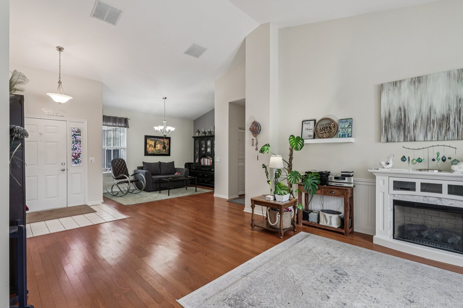688 Cadillac Circle Romeoville, IL 60446 - Photo 3 of 45 a living room with furniture and a fireplace