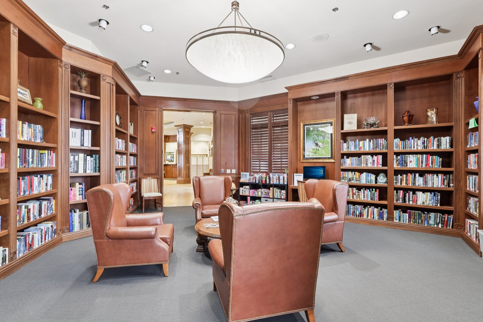 688 Cadillac Circle Romeoville, IL 60446 - Photo 31 of 45 a living room with furniture and a book shelf