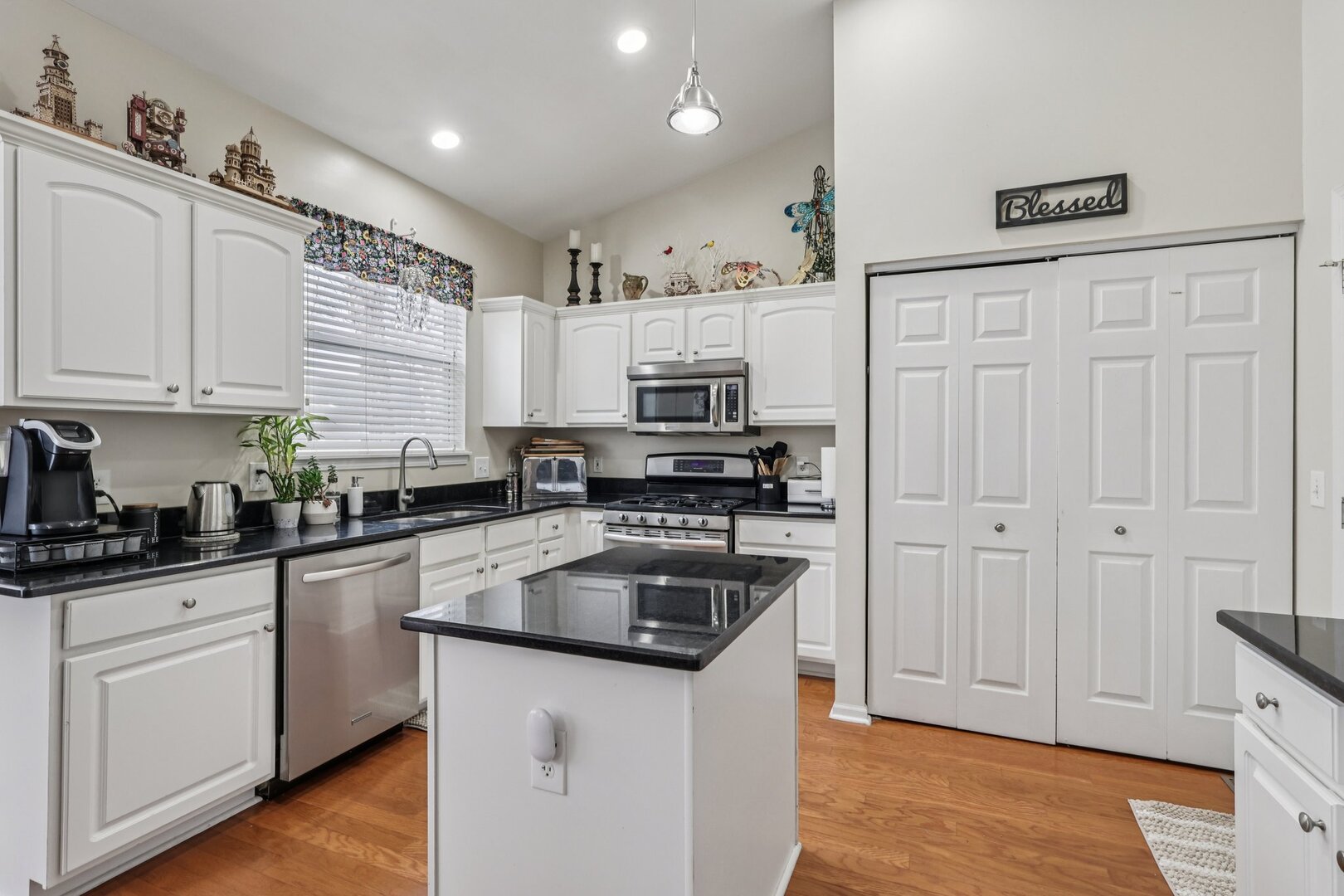 688 Cadillac Circle Romeoville, IL 60446 - Photo 9 of 45 a kitchen with granite countertop a sink a counter space stainless steel appliances and cabinets