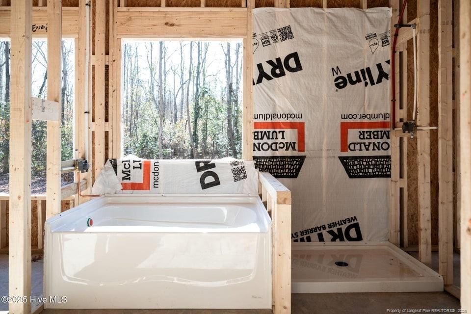 304 Monroe Road Cameron, NC 28326 - Photo 22 of 27 a bathroom with a bathtub and a shower