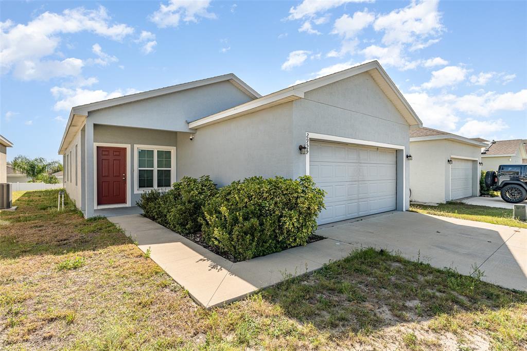 a view of a house with backyard and garden