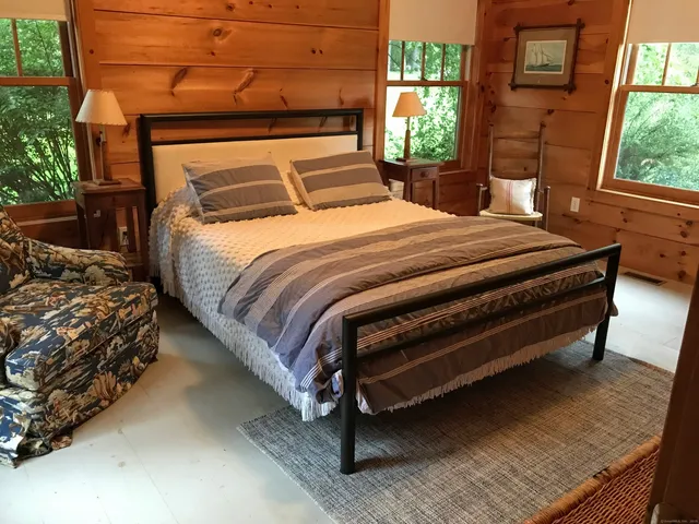 a bedroom with a bed and a window