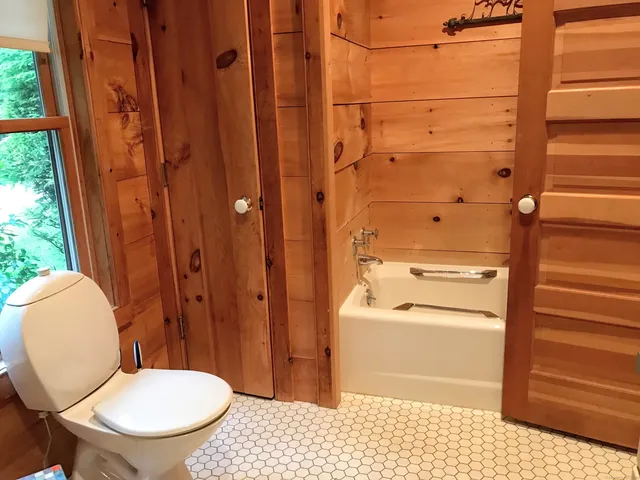 a bathroom with a toilet a sink and a window